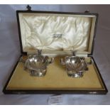 Pair of beautiful silver Omar Ramsden pedestal salts in bespoke wooden box, having scalloped rims