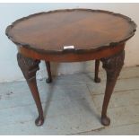 An early 20th century mahogany piecrust edged occasional table with a quarter veneered top, raised