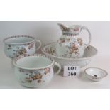 A five piece Edwardian toilet set including jug and bowl two chamber pots and a two part soap