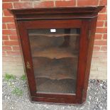 A 19th century oak wall hanging glazed corner cupboard with three shaped shelves. 102cm high x