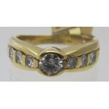 An 18ct yellow gold diamond ring set with centre diamond and three diamonds either side. Diamond