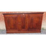 A Georgian mahogany inlaid and crossbanded enclosed low bookcase, the three doors enclosing an array