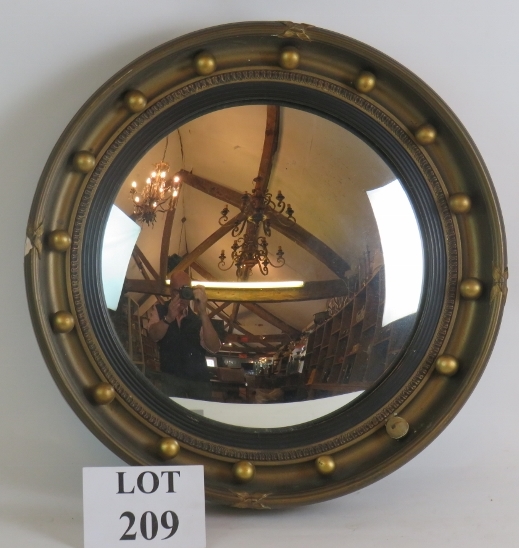 An early 20th Century Atsonea convex mirror in gilt plaster frame. Overall diameter 41cm.