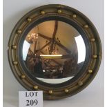 An early 20th Century Atsonea convex mirror in gilt plaster frame. Overall diameter 41cm.