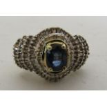 A 14ct yellow gold ring set with centre oval sapphire and surrounded by 2 rows of baguette cut