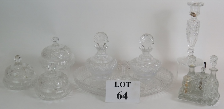 A four piece cut crystal dressing table set, three similar covered jars, a cut glass candlestick and