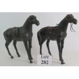 A pair of 20th Century leather horses, height 34cm. Condition report: Both with losses, one with