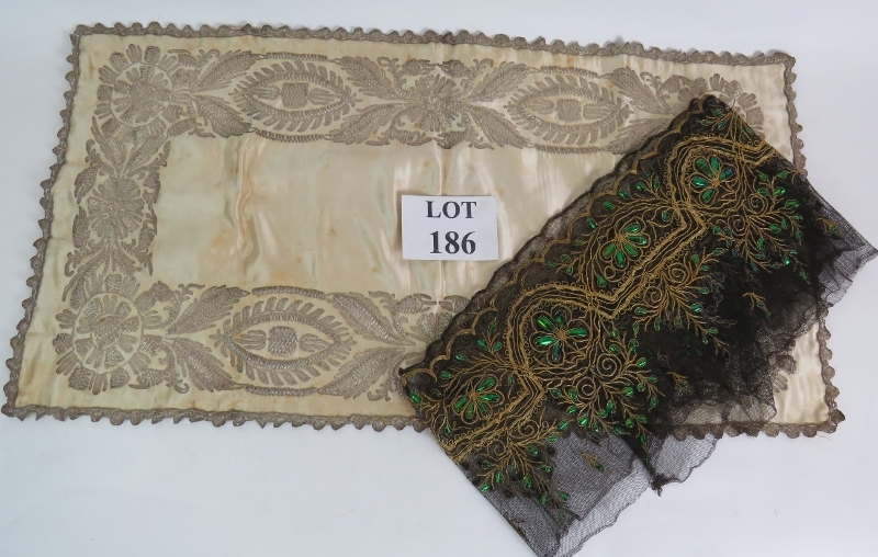 An antique finely worked silk panel with white metal thread possibly silver (80cm x42cm), plus a