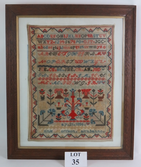 A 19th Century Scottish needlework sampler in oak frame, signed Annie Morrison Cairnbanno May 21st