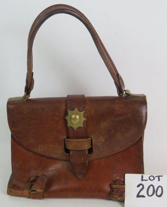 A handmade vintage leather bag with internal dividers and mounted with brass military badge. 27cm