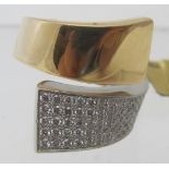 A heavy 18ct yellow gold and platinum wrap over ring, the platinum side encrusted with five bands of