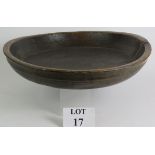 A large antique country oak dairy or dough bowl with turned rim and aged patination. Max diameter