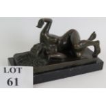 A Contemporary bronze figure of a recumbent nude signed Milo and mounted on a black marble base.