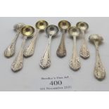 A set of eight silver salt spoons with gilded bowls and embossed foliate finials, Birmingham 1906,