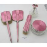 A three piece silver & pink enamelled dressing table set, comprising of hand mirror, hand brush &