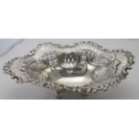 A silver openwork dish on ball feet decorated with bows & swags with foliate design around the edge,