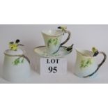 A three piece Graff porcelain tea set with bird on branch handles and decoration, comprising cup and