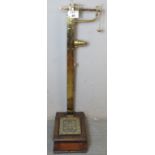 A set of Victorian brass and oak stand on Avery weighing scales with complete set of weights,