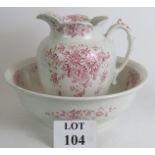 A late 19th/early 20th Century ceramic toilet jug and bowl with relief decoration and peuce floral