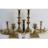 A pair of antique brass aesthetic movement candlesticks, a pair of tall Georgian style candlesticks,