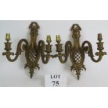 A pair of heavy cast gilt brass double wall sconces in the Louis XV style. Height 29cm. Width