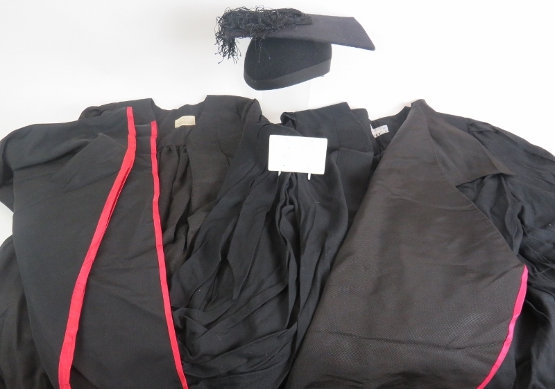 Two black graduation gowns and a mortar board size 6 5/8. (5). Condition report: No issues.