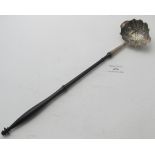 A Georgian silver toddy ladle with embossed panels of flower & leaf design, wooden handle, London