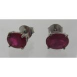 A pair of treated ruby studs, marked 925, approx weight 1.6 grams. Condition report: Good condition.