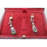 A pair of drop earrings set with cabochon peridots & round cut diamonds, approx weight 3 grams.