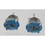 A pair of blue topaz stud earrings, indistinct markings on back, approx weight 1.6 grams.