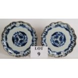 A pair of antique Chinese porcelain scallop edged plates decorated in blue and white with gilded