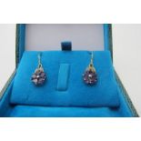 A pair of flower design drop earrings set with amethysts & diamonds, boxed, approx 2.3 grams, marked