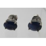 A pair of treated sapphire stud earrings, posts stamped 925. Condition report: Slight chips on the