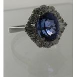 An 18ct white gold oval cut loupe clean tanzanite & diamond cluster ring. Tanzanite approx 3cts,