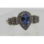 A 9ct yellow gold tanzanite and diamond ring. The pearl shaped tanzanite approx 8mm x 5mm and