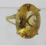 A large 11ct citrine solitaire ring, 18mm x 13mm, oval brilliant cut, 14k yellow/925, size N, approx