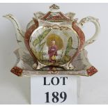 A late 19th Century aesthetic movement teapot and stand probably by Burgess & Leigh. REGD No 225655,