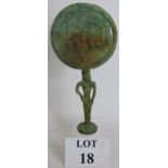 An Etruscan style bronze mirror possible Archaic, formed from an open armed figural handle