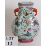 An antique Chinese porcelain vase richly enamel decorated with butterflies and flowers. Seal mark to