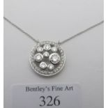 A fine diamond cluster slide pendant, probably 18ct white gold, on a fine platinum chain. The