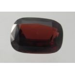 A single loose large unmounted cushion cut garnet, approx 10.54cts. Condition report: Good