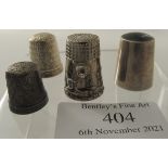 A collection of four hallmarked or stamped 925 thimbles to include a plain thimble with quartz