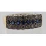 An 18ct yellow gold ring set with two lines of diamonds and one of sapphires, size Q, approx