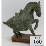 A heavy bronze Chinese Tang style horse on hardwood stand, previously drilled for use as a lamp.