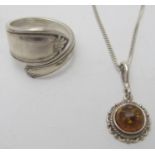 A silver cross over ring, size N, Sheffield 1945 and a small amber pendant on a 925 stamped chain.