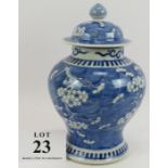 An antique Chinese porcelain covered jar of baluster form decorated with blue prunus design. Four