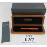 A brand new Parker Duo Fold fountain pen with orange body and 18k nib, in cherry wood presentation