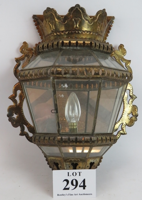 A pierced metal Persian style glazed wall light with mirrored back. Height 43cm. Width 34cm.