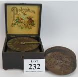 A small antique polyphon music box with 18 6.5" discs. The lid decorated with flowers. 20cm x