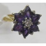 An 18ct yellow gold amethyst & diamond cluster ring, the centre diamond approx 20pts, the six